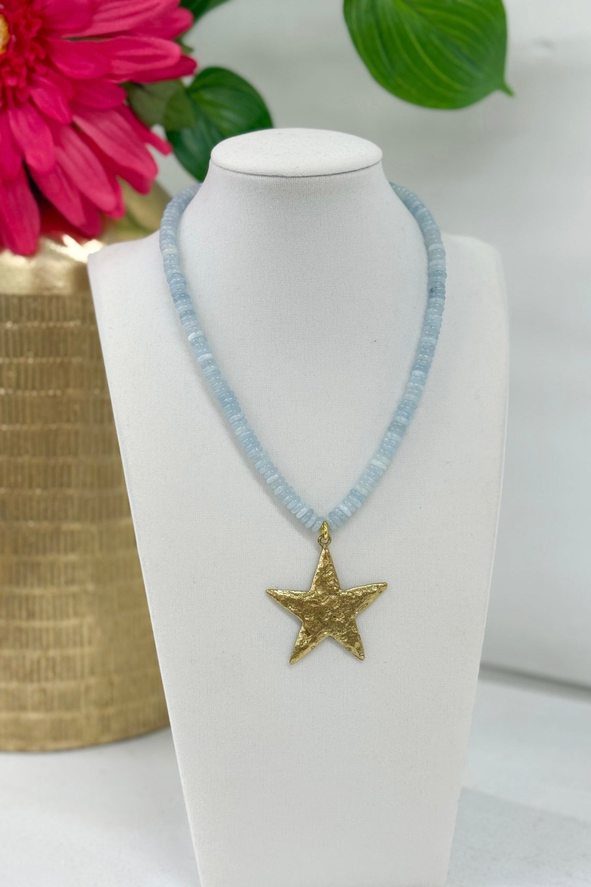 Pale blue beaded necklace with a star charm