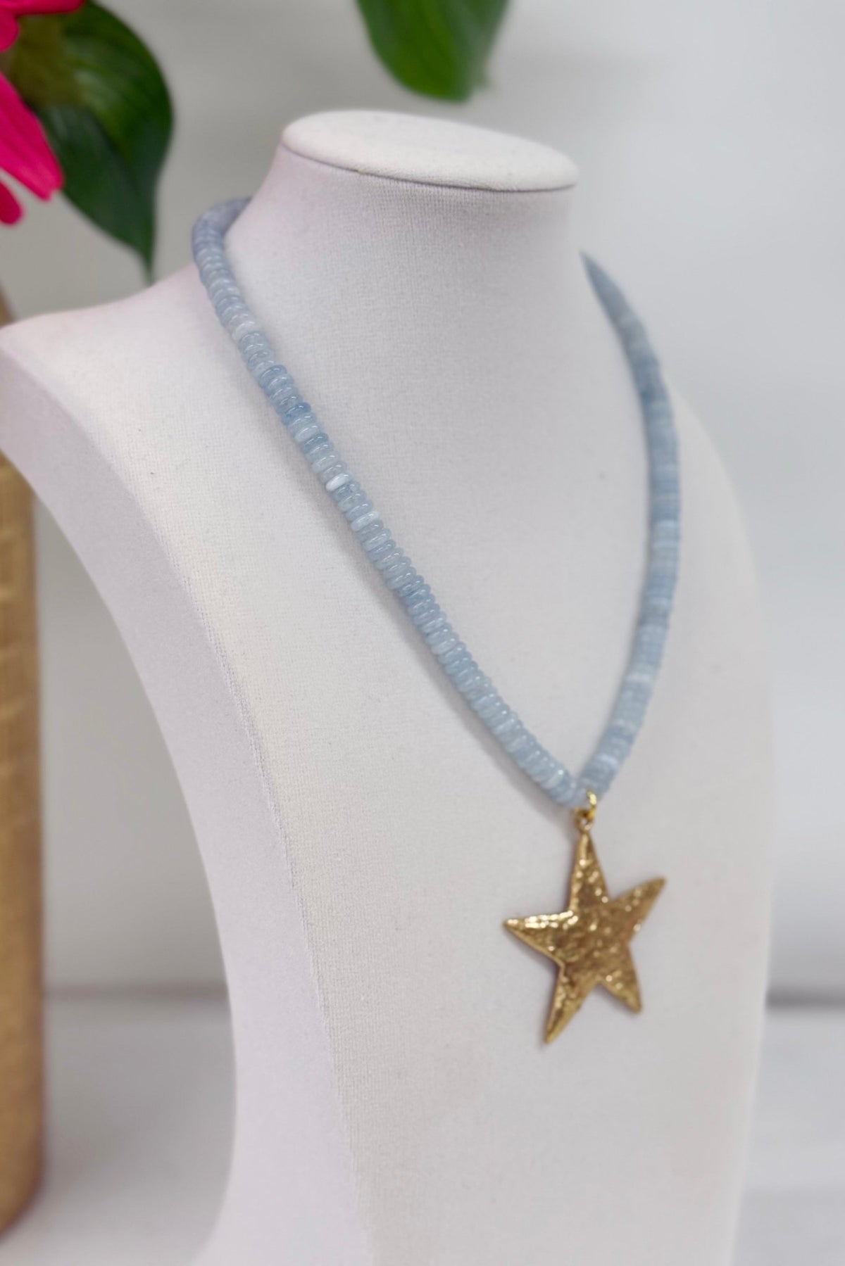 Star charm on a pale blue beaded strand