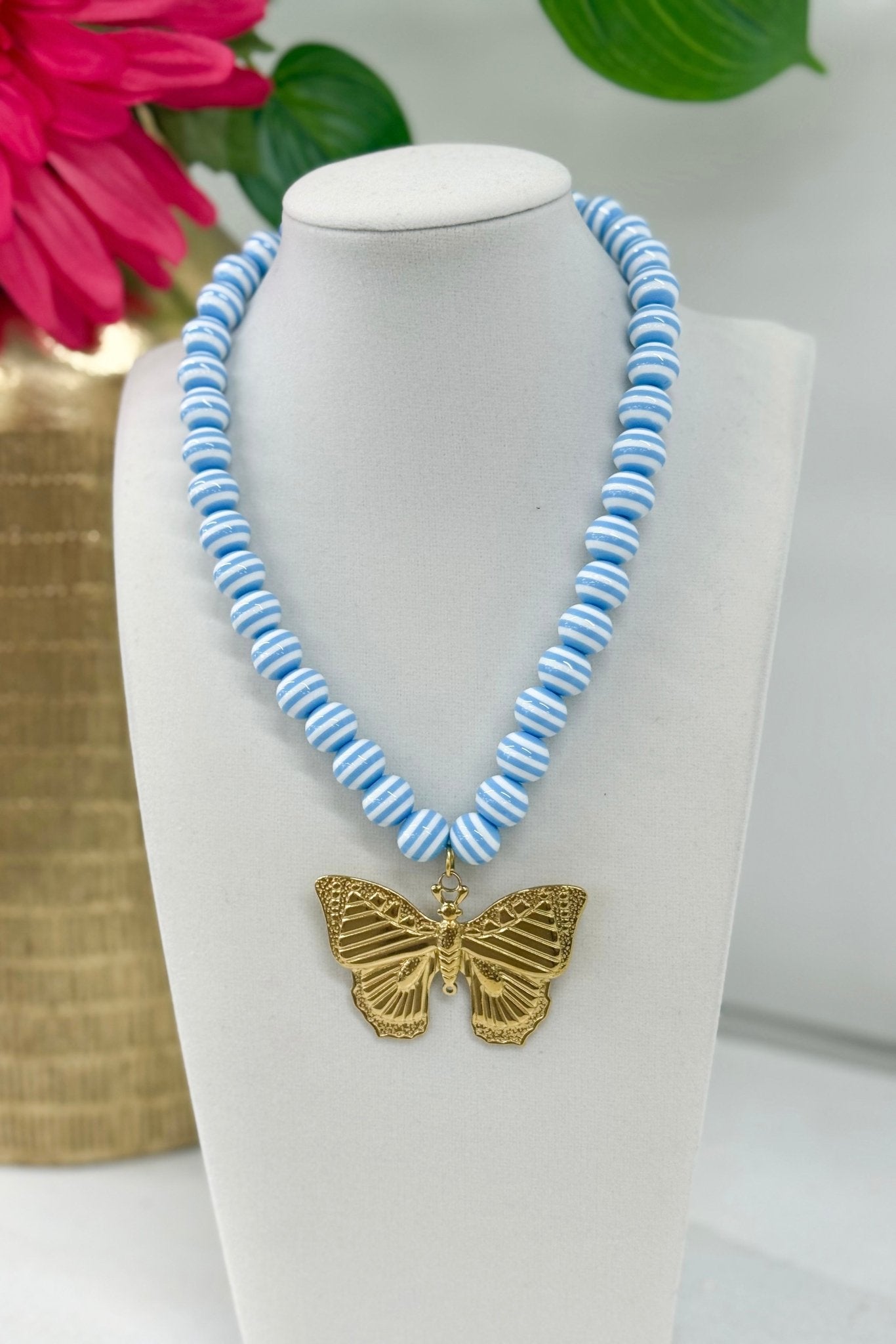 Striped bead necklace with a butterfly pendant