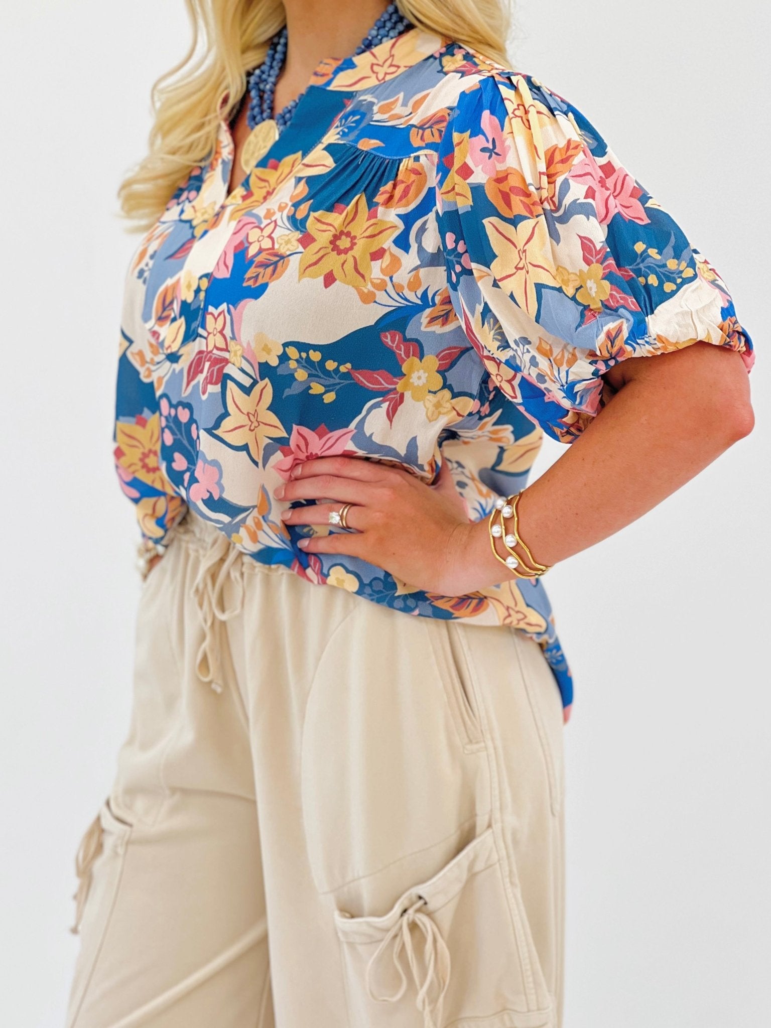 Dusty blue floral puff sleeve top with a v-neckline