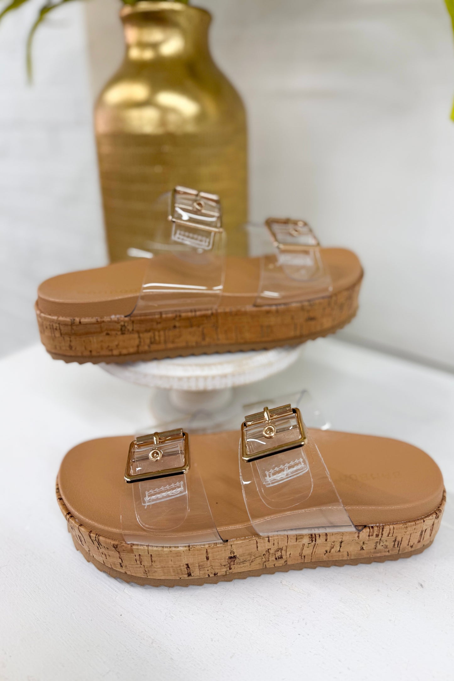 Double buckle slide sandals with clear straps, taupe footbed, cork-style platform