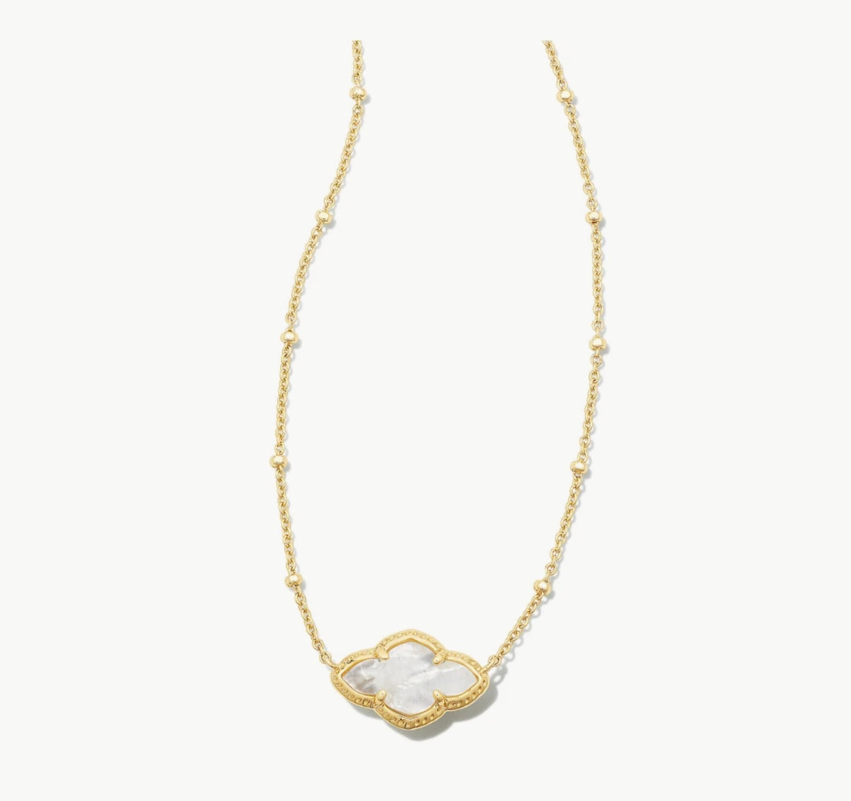 Gold pendant necklace with ivory MOP heart charm at center on beaded chain
