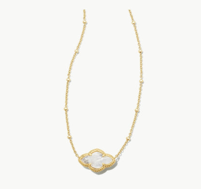 Gold pendant necklace with ivory MOP heart charm at center on beaded chain