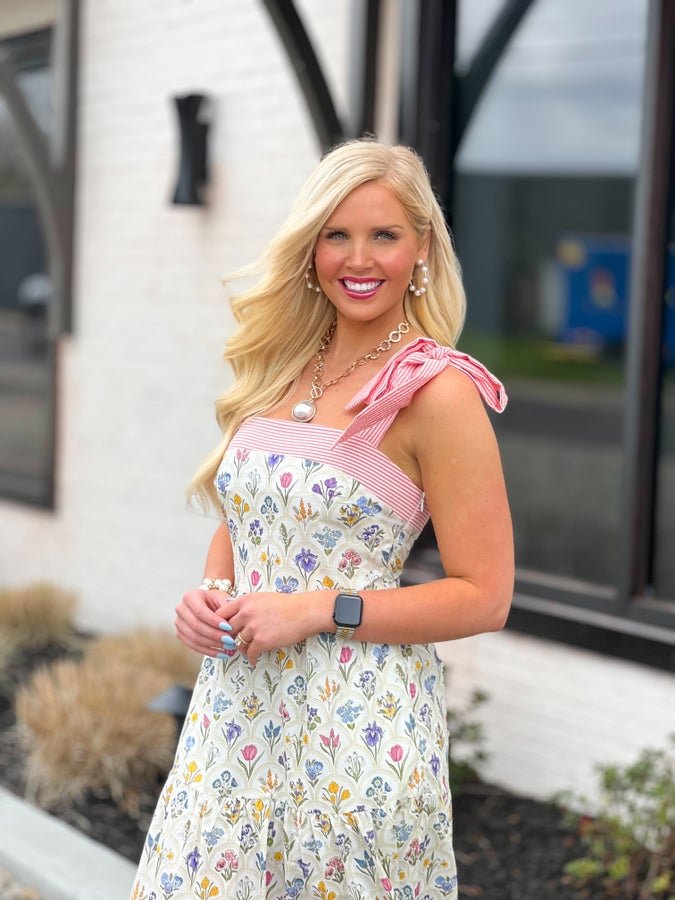 Ribbon ties on an ivory multi floral midi dress