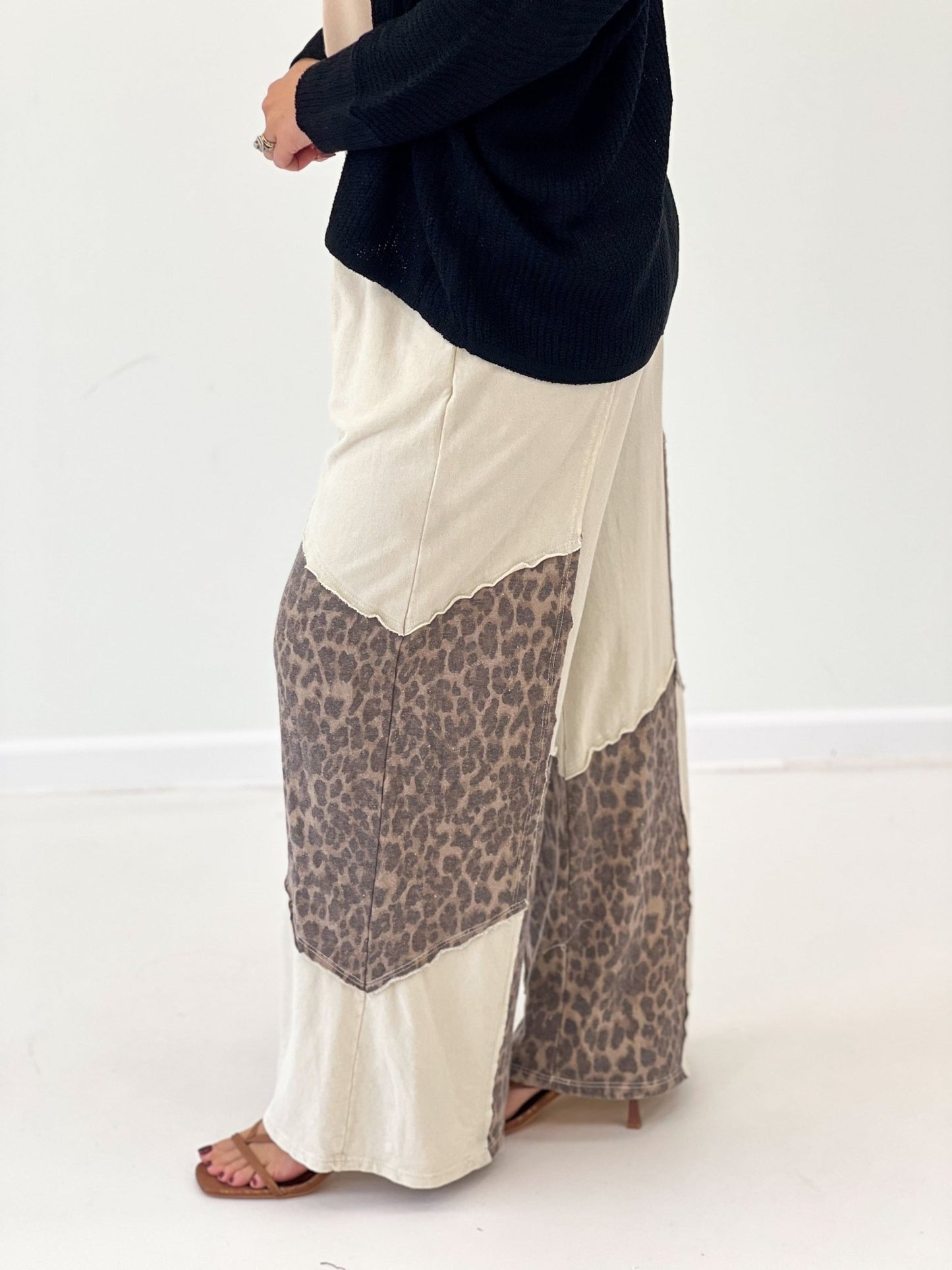 Cream wide-leg pants with leopard print front panel and elastic waistband