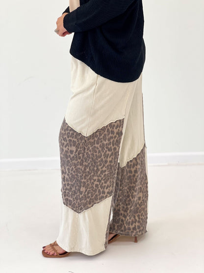 Cream wide-leg pants with leopard print front panel and elastic waistband