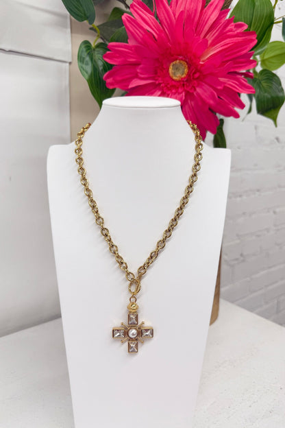 Cross pendant on a fine gold chain