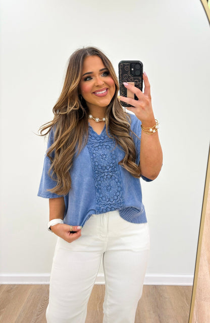 Denim blue v-neck top with a faded wash finish