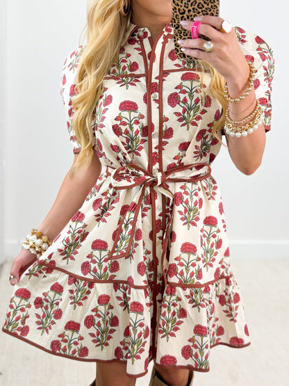 Button placket on an ivory flower detail dress