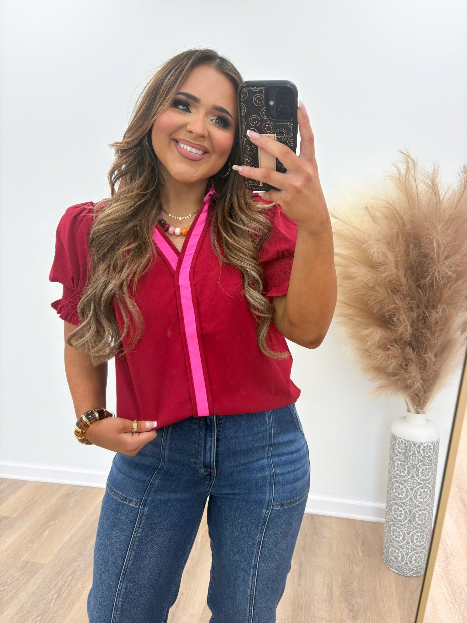 Wine coloured v-neck top with a pointed collar