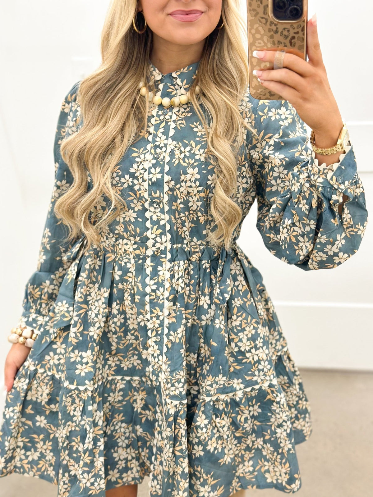 Dusty teal floral dress with a full button front and long sleeves