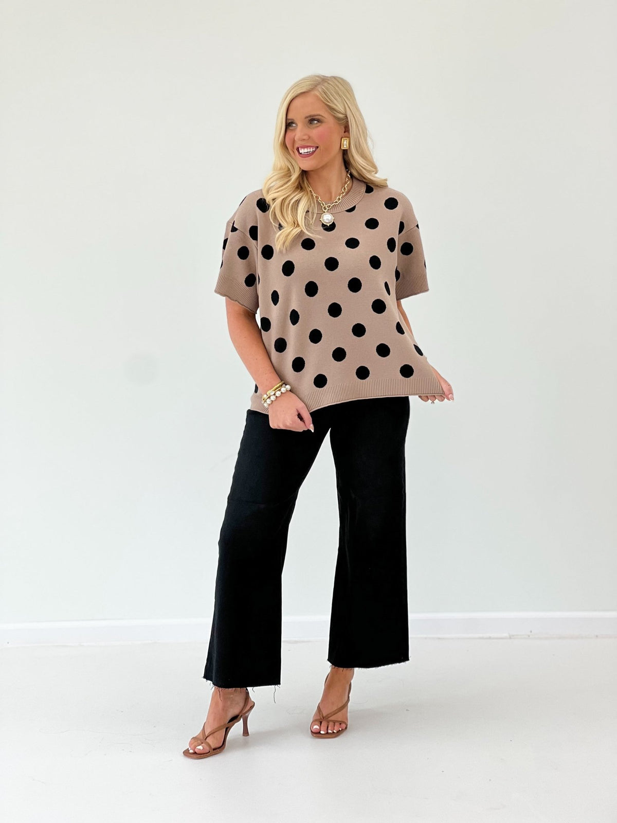 Taupe polka dot knit top with a round neckline