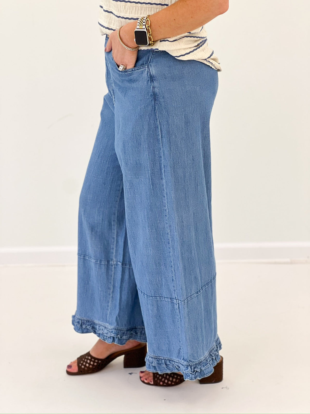 Denim pants with a full wide leg and ruffle trim