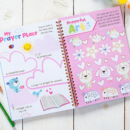 Kids spiral notebook journal open to purple “Prayful” prayer place page with hearts
