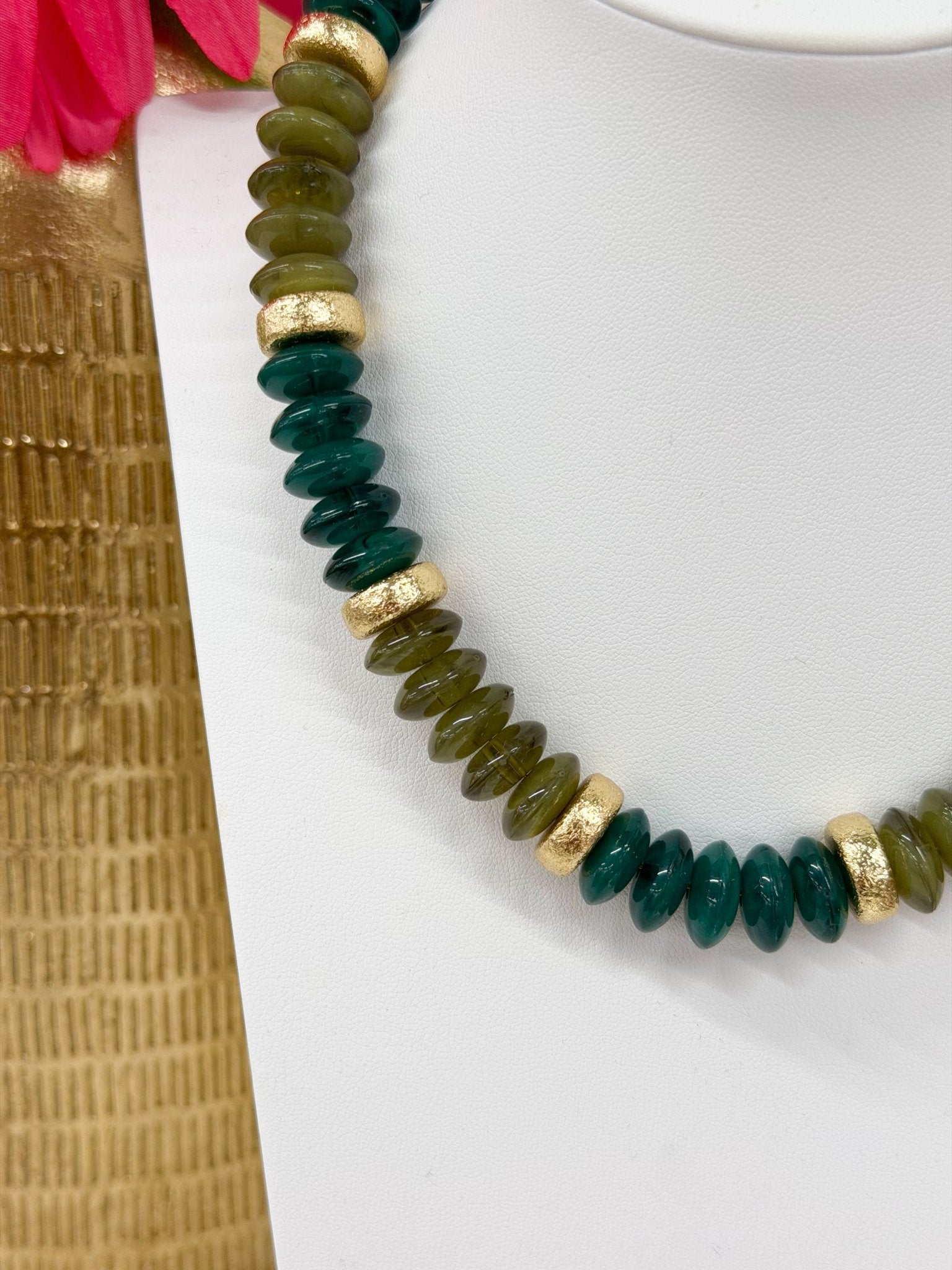 Strand of mixed green beads with gold-tone accents