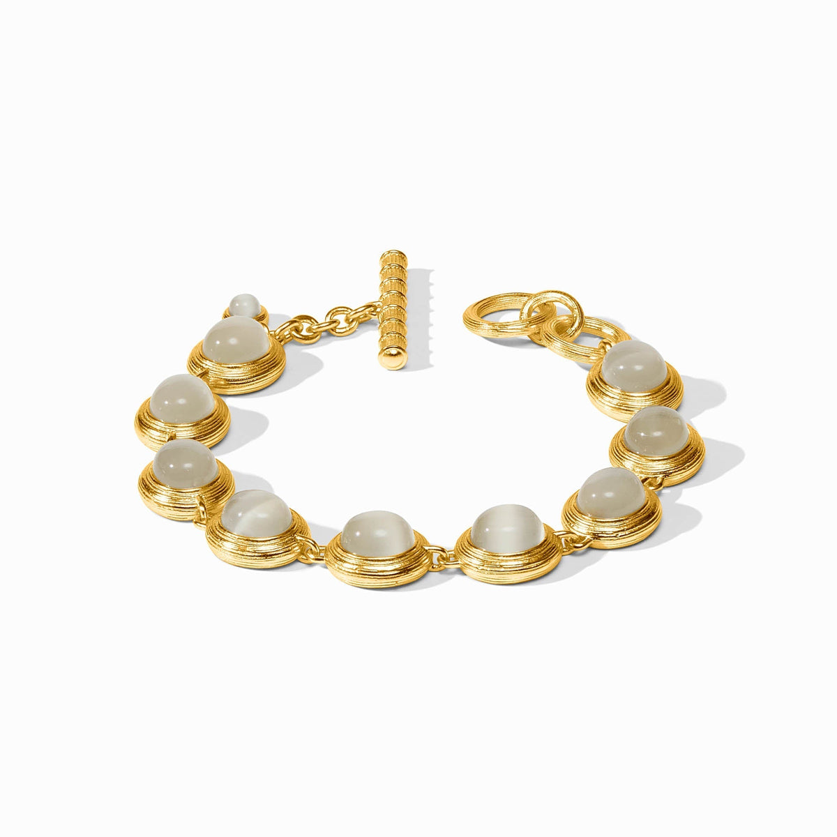 Gold tennis bracelet lined with ivory cat's eye stones
