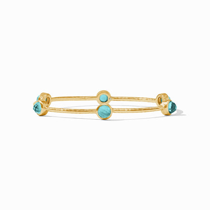 Gold luxe bangle set with a single colored stone