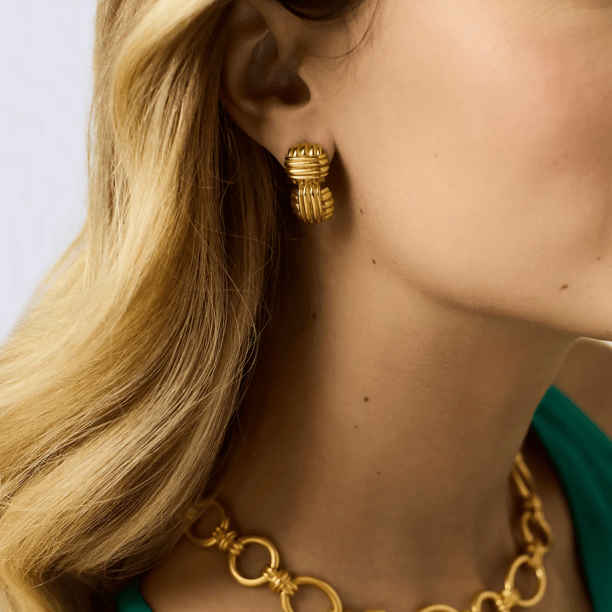 Mid-size gold earrings with a sculpted profile
