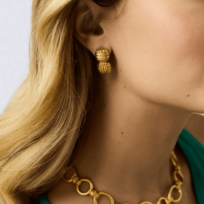 Mid-size gold earrings with a sculpted profile