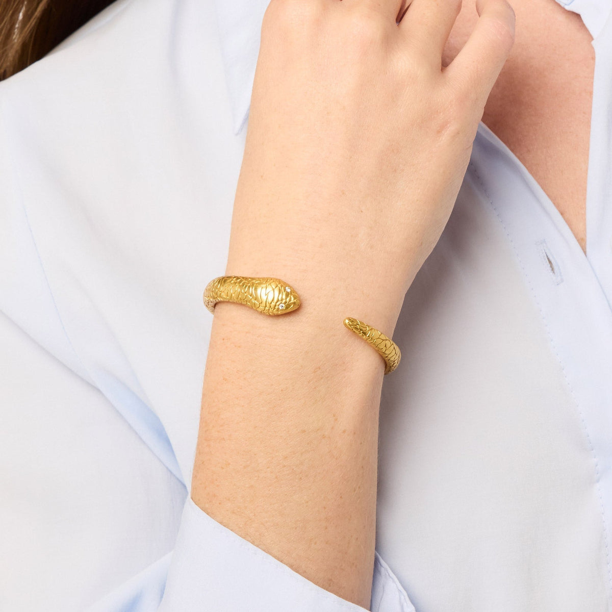 Coiled snake-form cuff in gold with sparkling stone detail