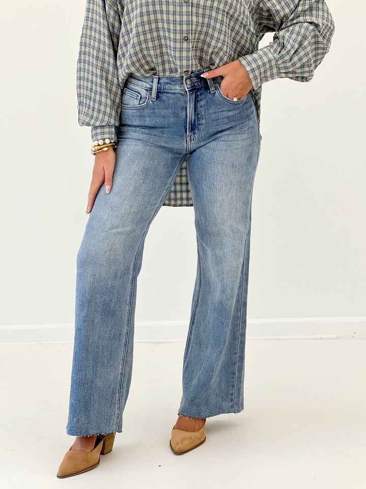 Medium wash wide leg jeans with a five pocket cut