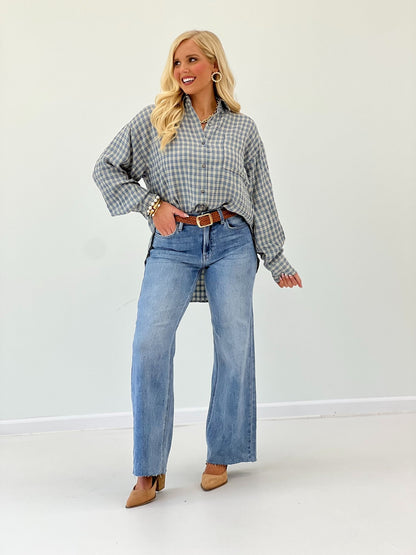 Wide leg jeans in a medium wash with a button and zip front