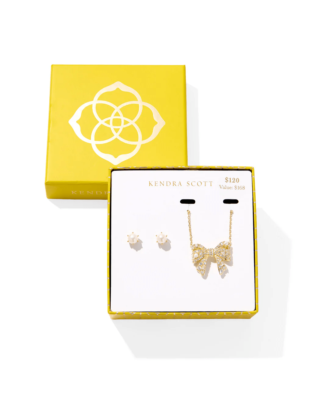 Gold jewelry set with bow earrings and a white beaded necklace