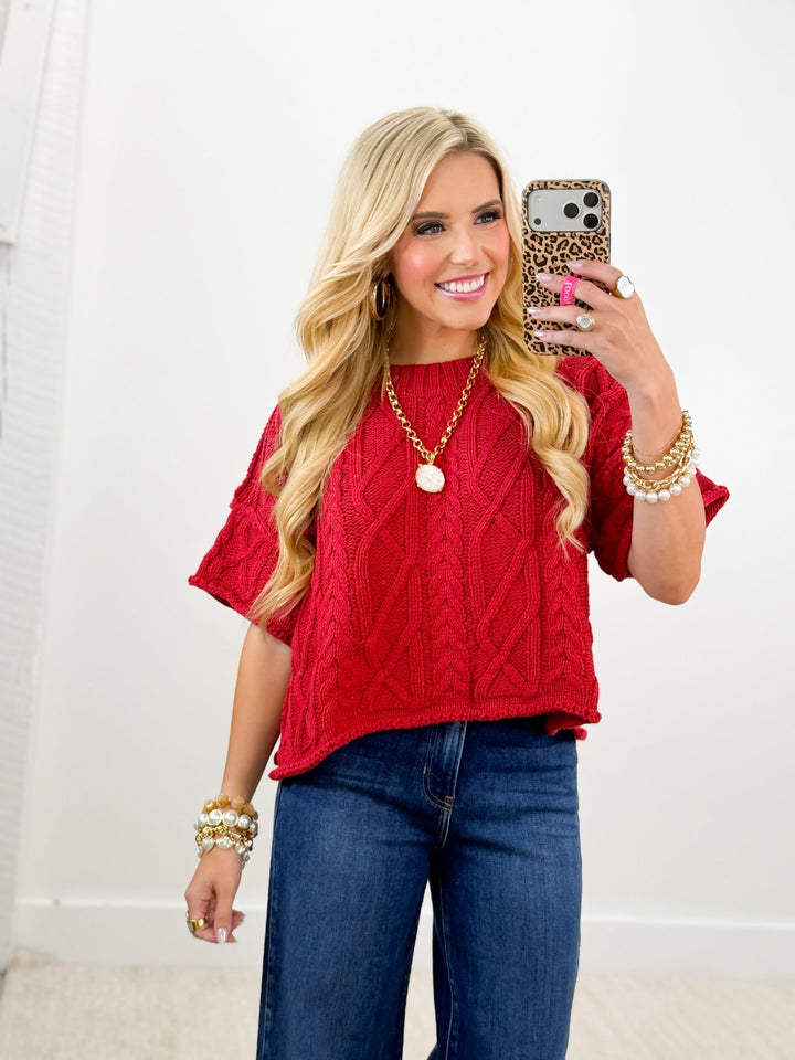 Dark red knit sweater with short sleeves and a round neck