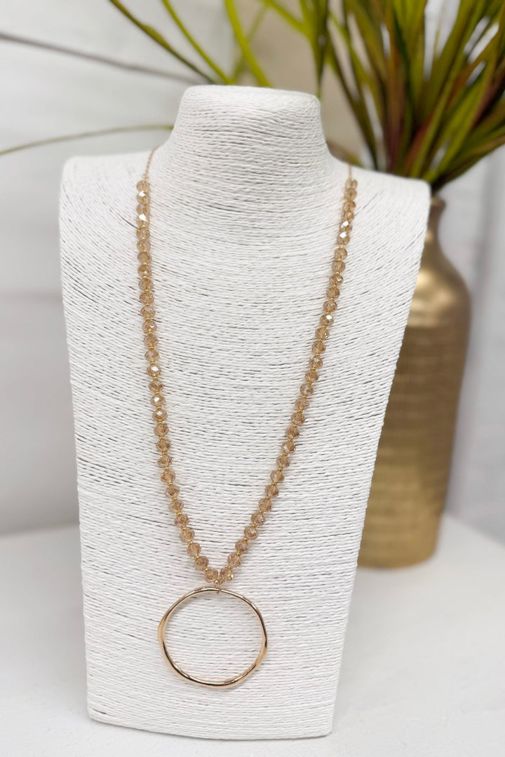 Long champagne glass bead necklace with a circle pendant
