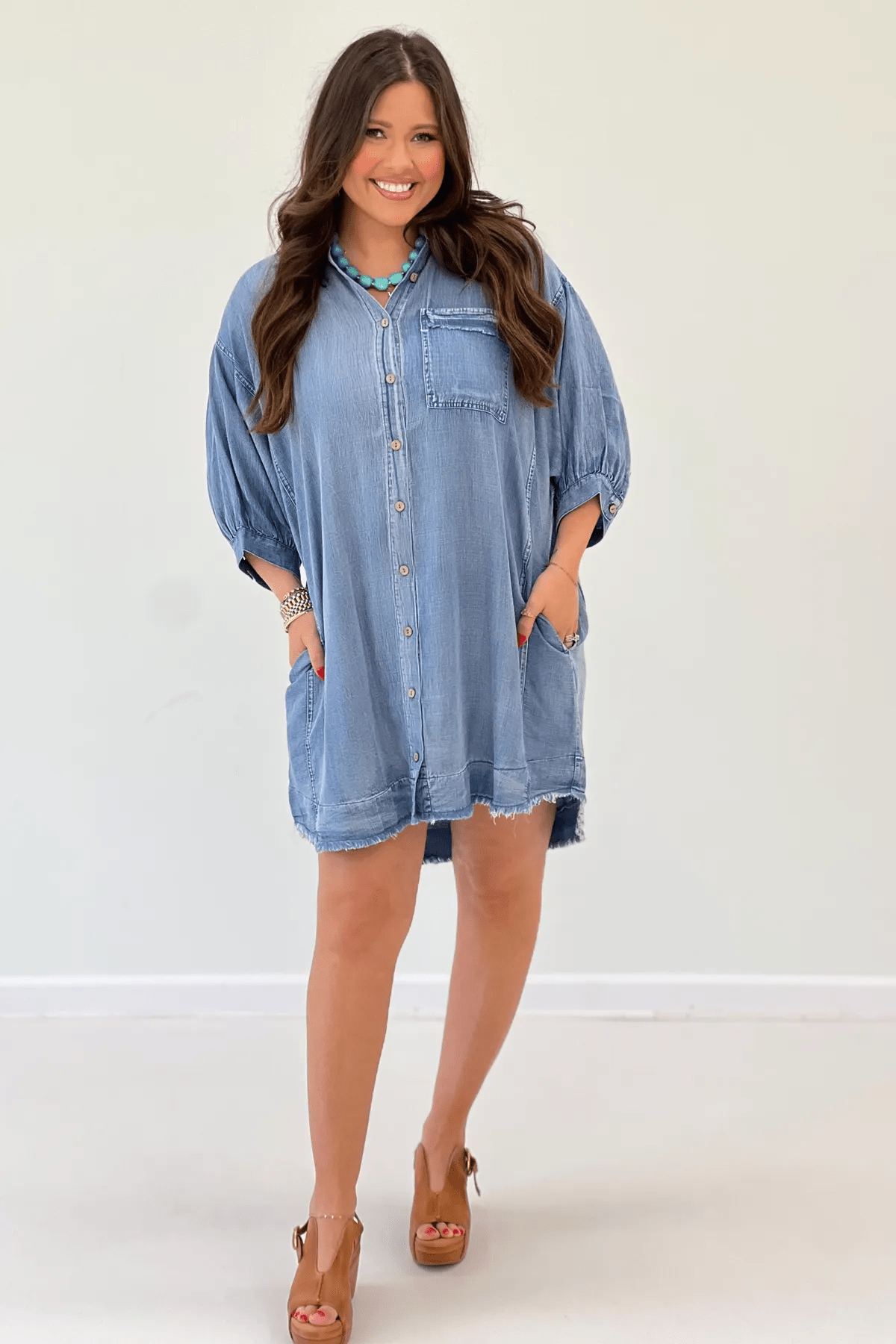 Light denim dress with a button front and raw hem