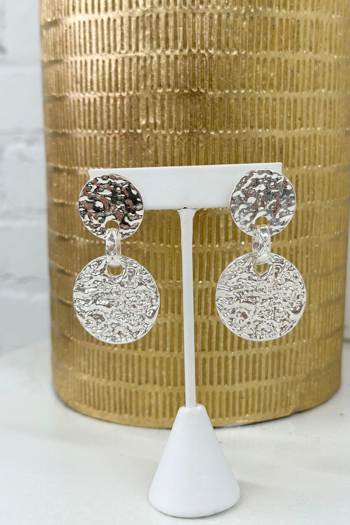 Hammered metal disks linked into drop earrings