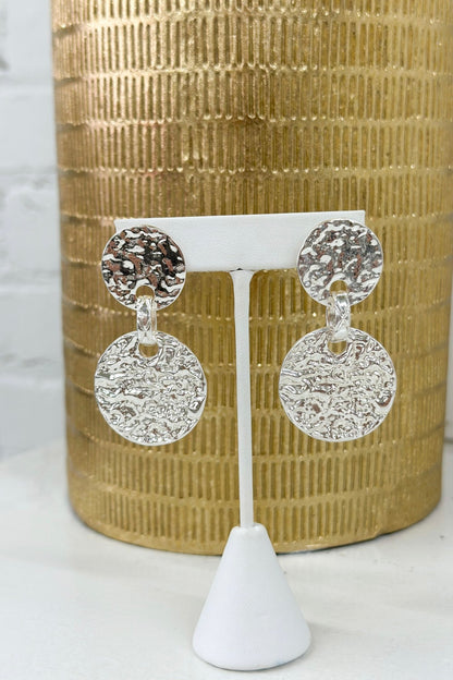 Hammered metal disks linked into drop earrings