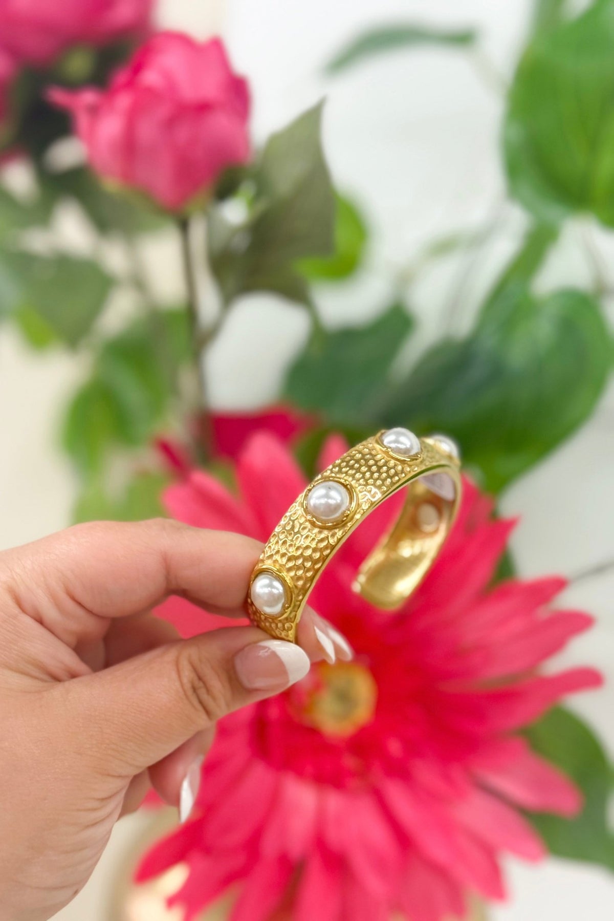 Gold bangle with pearls along the band