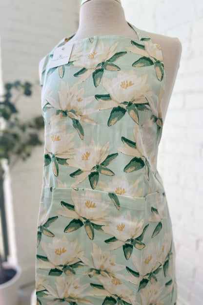 Magnolia print kitchen apron in mint