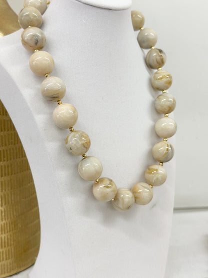 Necklace strung with round marble beads