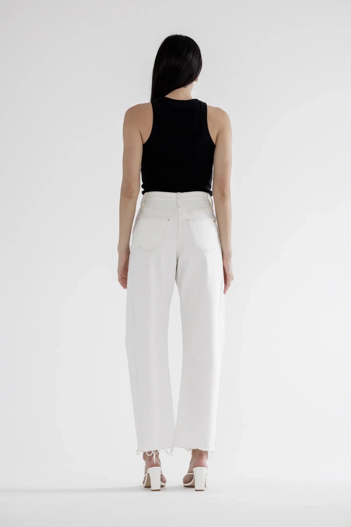 White wide leg jeans with a frayed raw hem and high waist