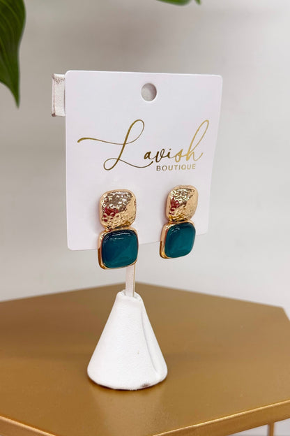 Gold earrings with a glossy mint green cat eye stone