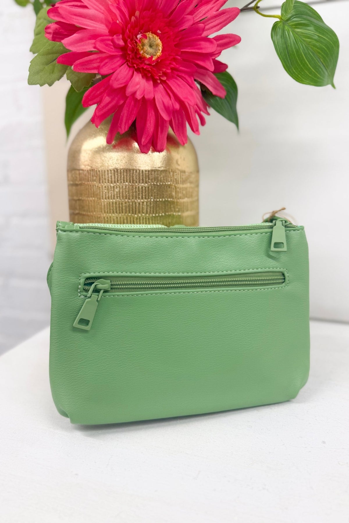 Mint green straw bag with a crossbody strap