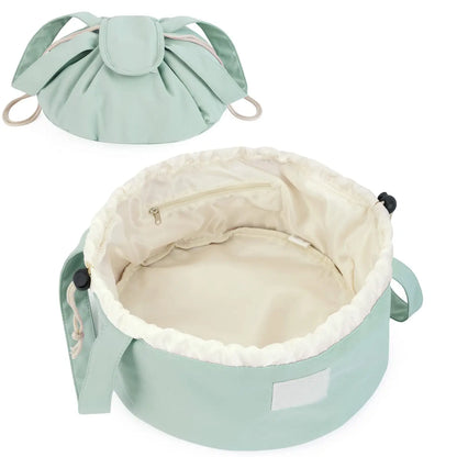 Mint green barrel makeup bag with drawstring closure, handles, and cream-lined interior