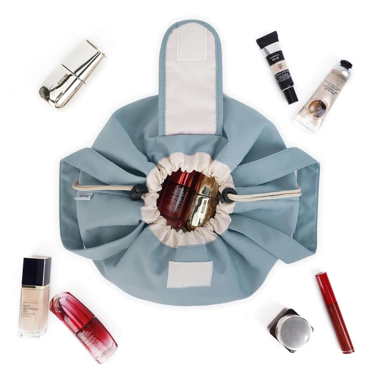 Grey-blue drawstring makeup bag opened flat to show its gathered closure and handles