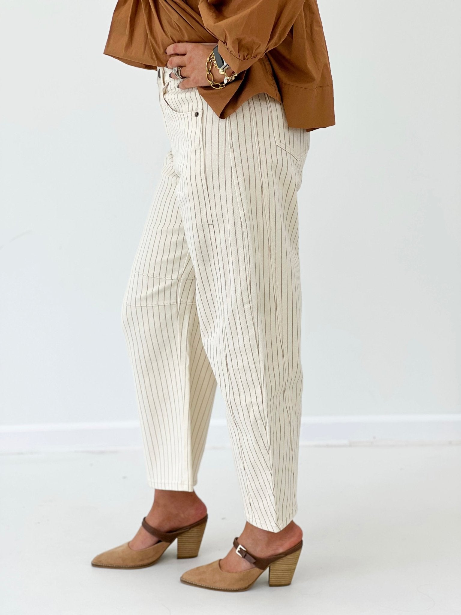 Pinstriped cream barrel pants with a high waist
