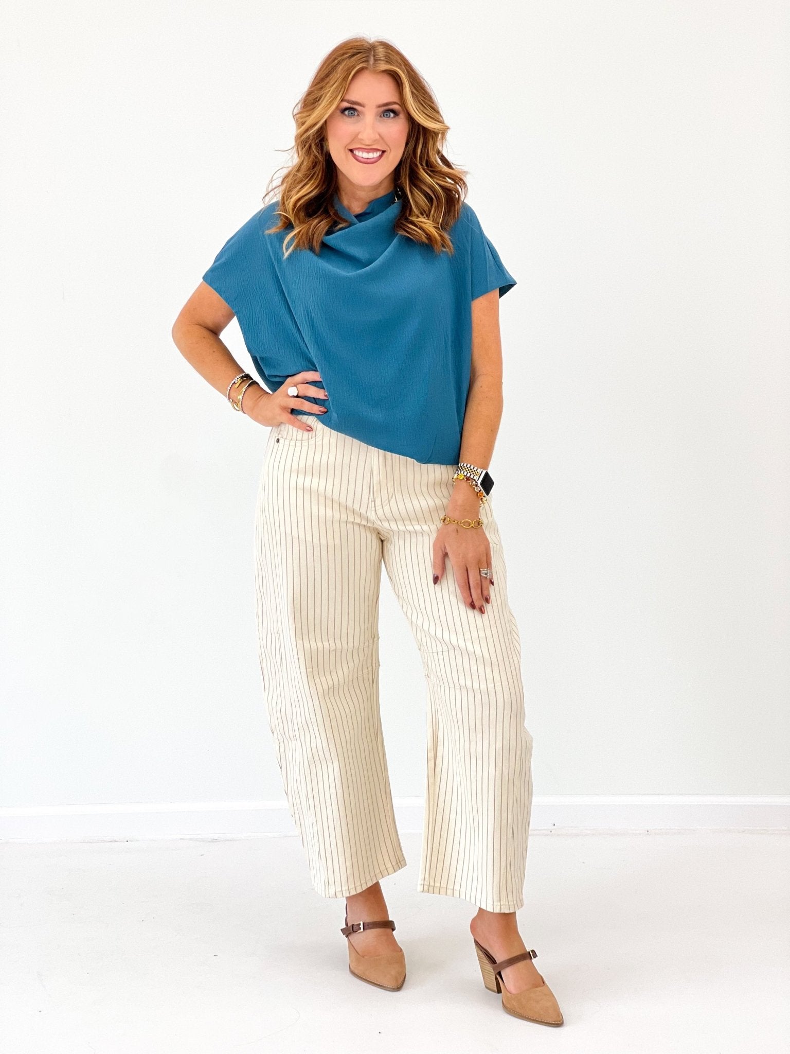 Cream striped pants with a curved barrel leg