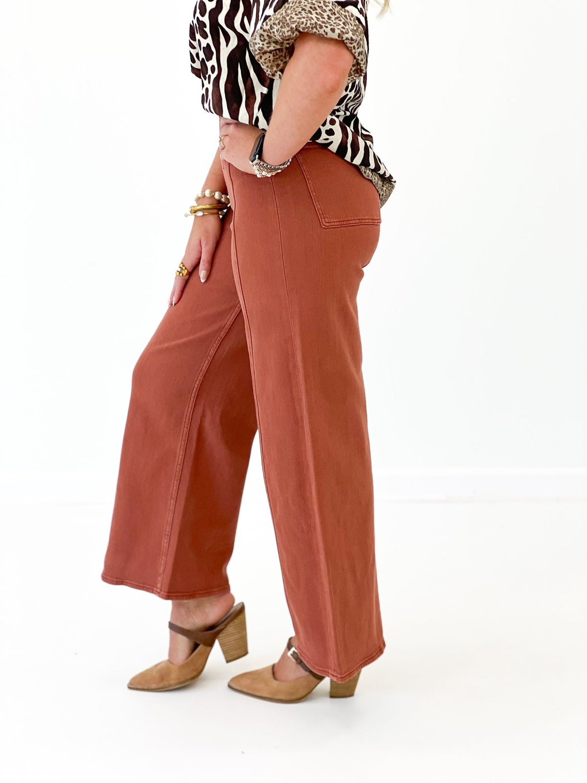 Terracotta stretch pants with a faded wash finish