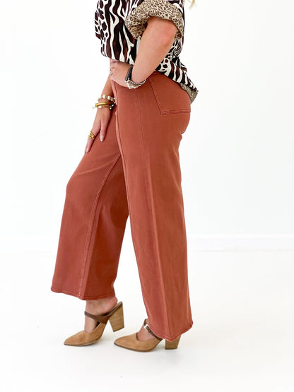 Terracotta stretch pants with a faded wash finish