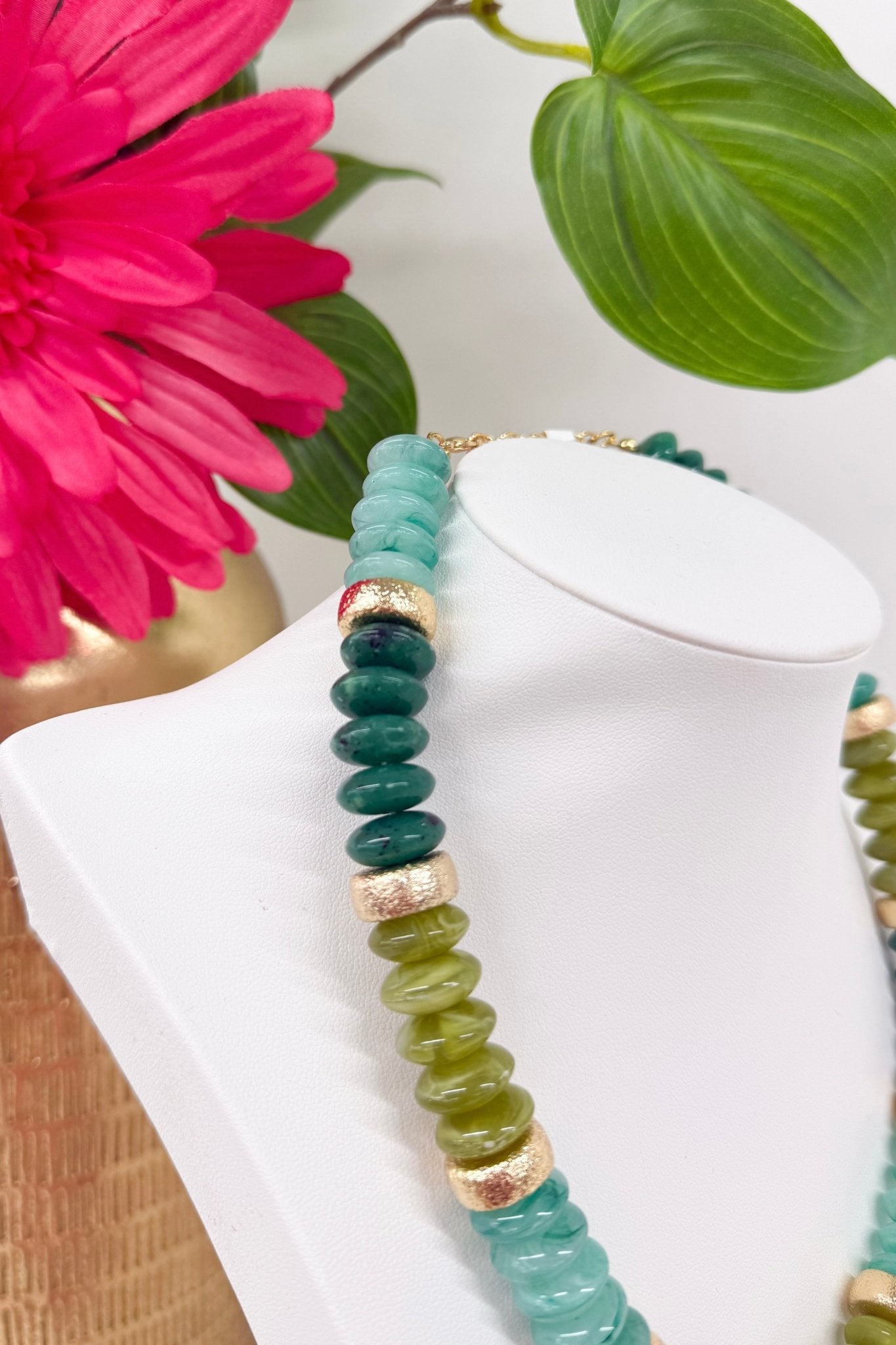 Strand of olive green beads with gold rounds