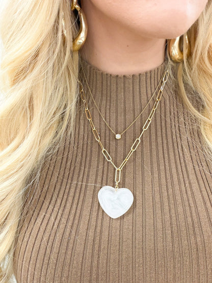 Gold paperclip link chain with a heart charm