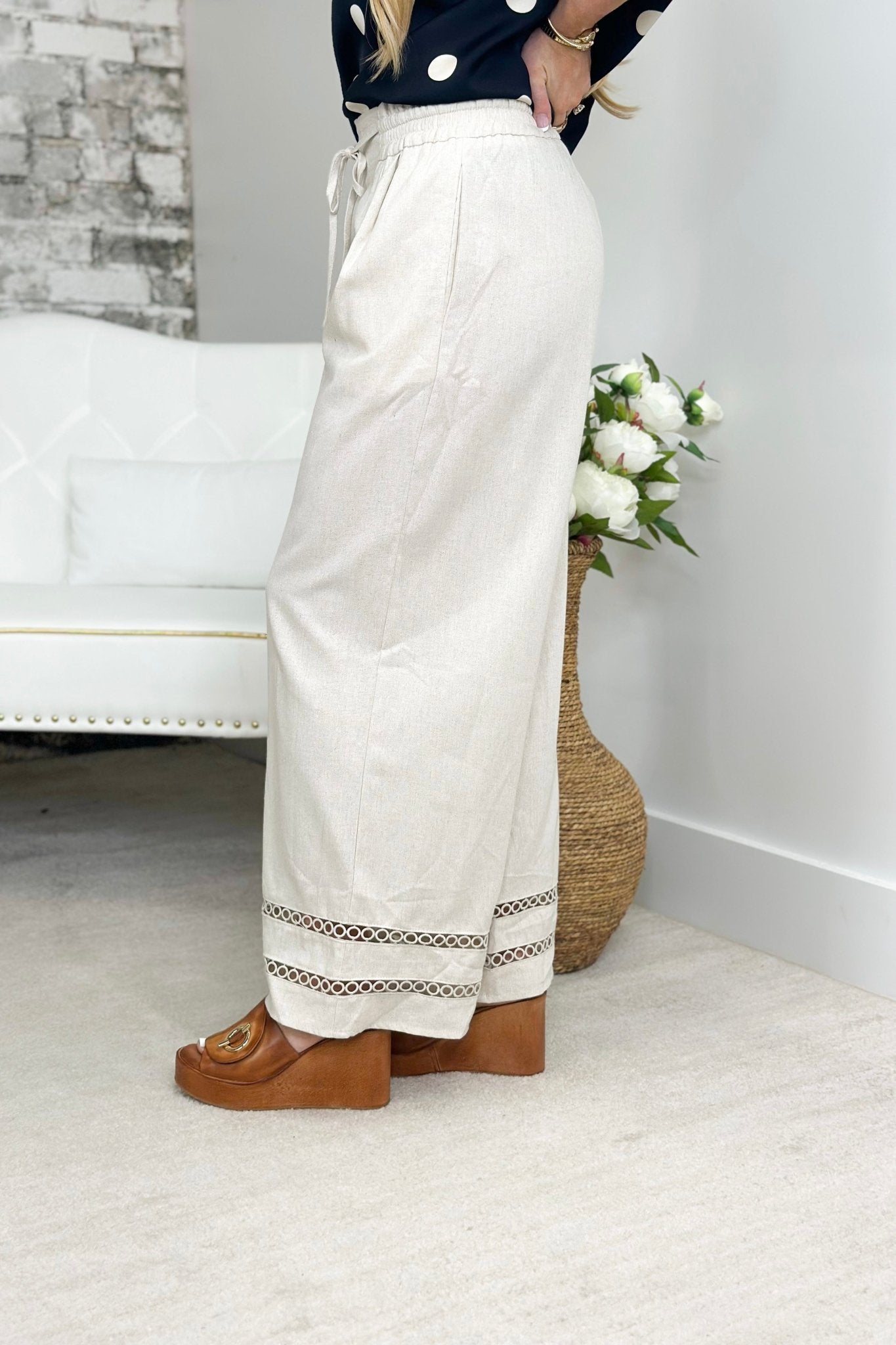 Linen trousers with an embroidered trim at the hem