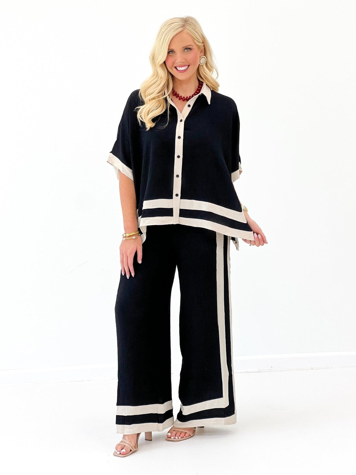Black short-sleeve shirt and wide-leg pants set with bold contrast border