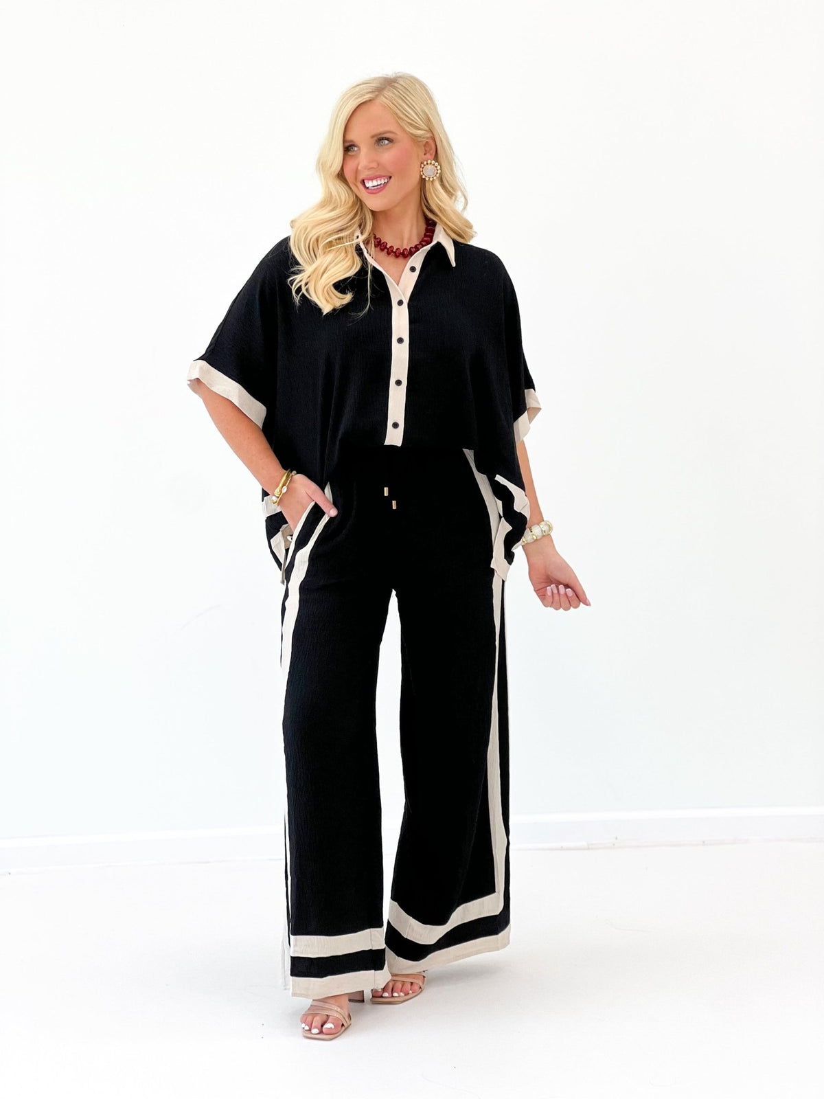 Black wide-leg pants set with open-front short-sleeve shirt and contrast stripes