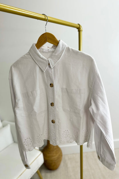 Cropped off white jacket with an eyelet finished hem